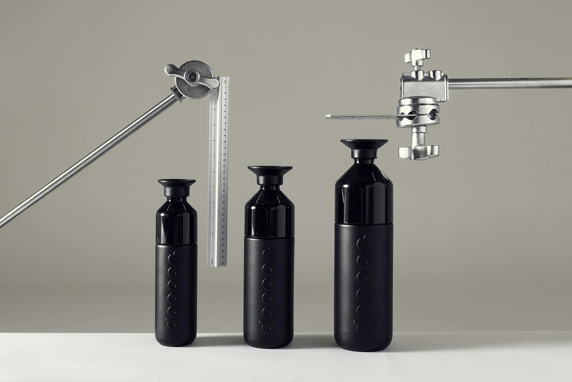 Three black Dopper bottles in each a different size