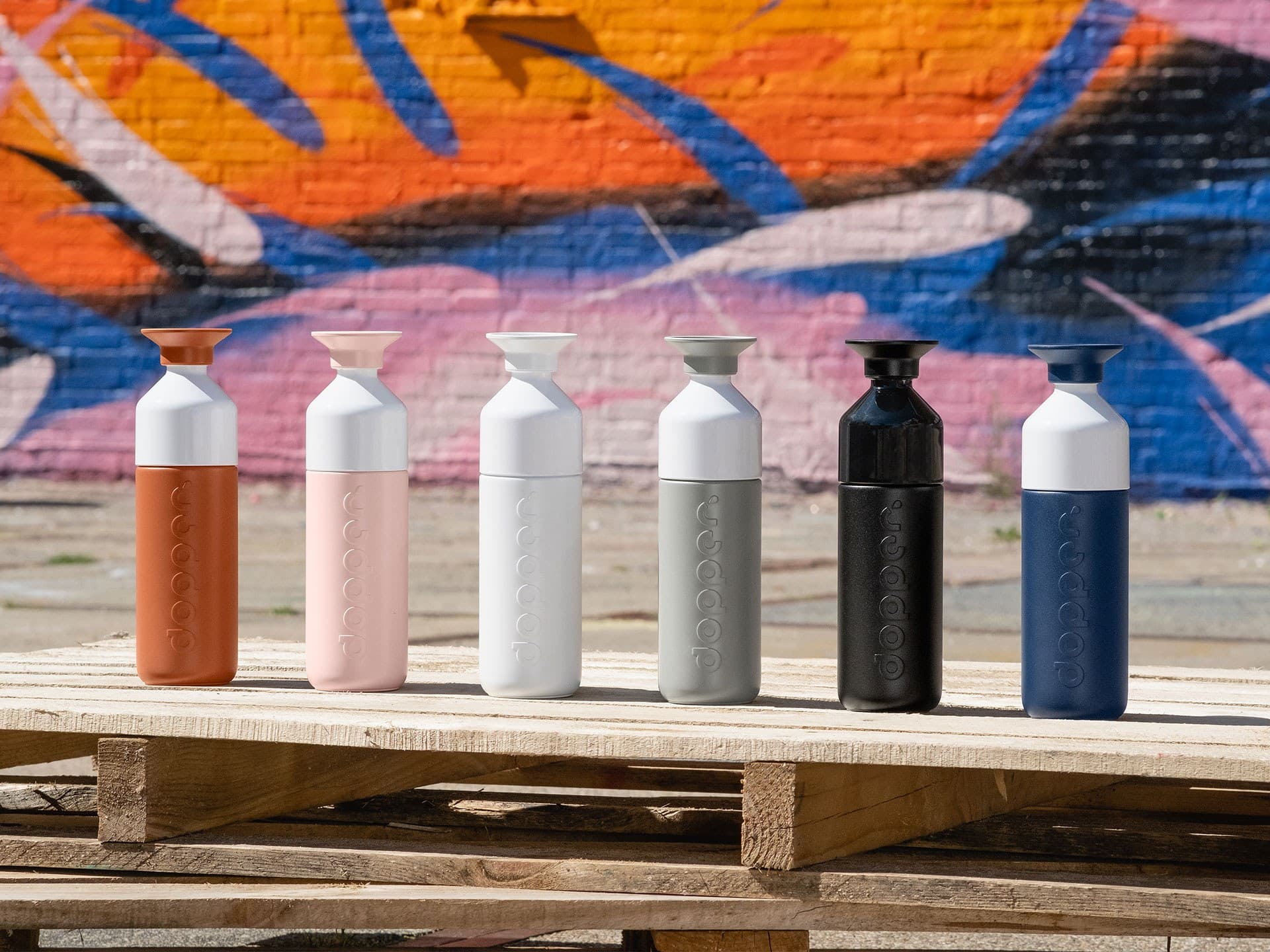 Line up of 6 different coloured Dopper Insulated bottles