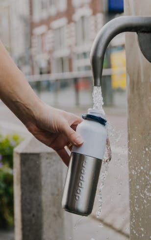 Reusable Dopper Steel being refilled at a public water tap
