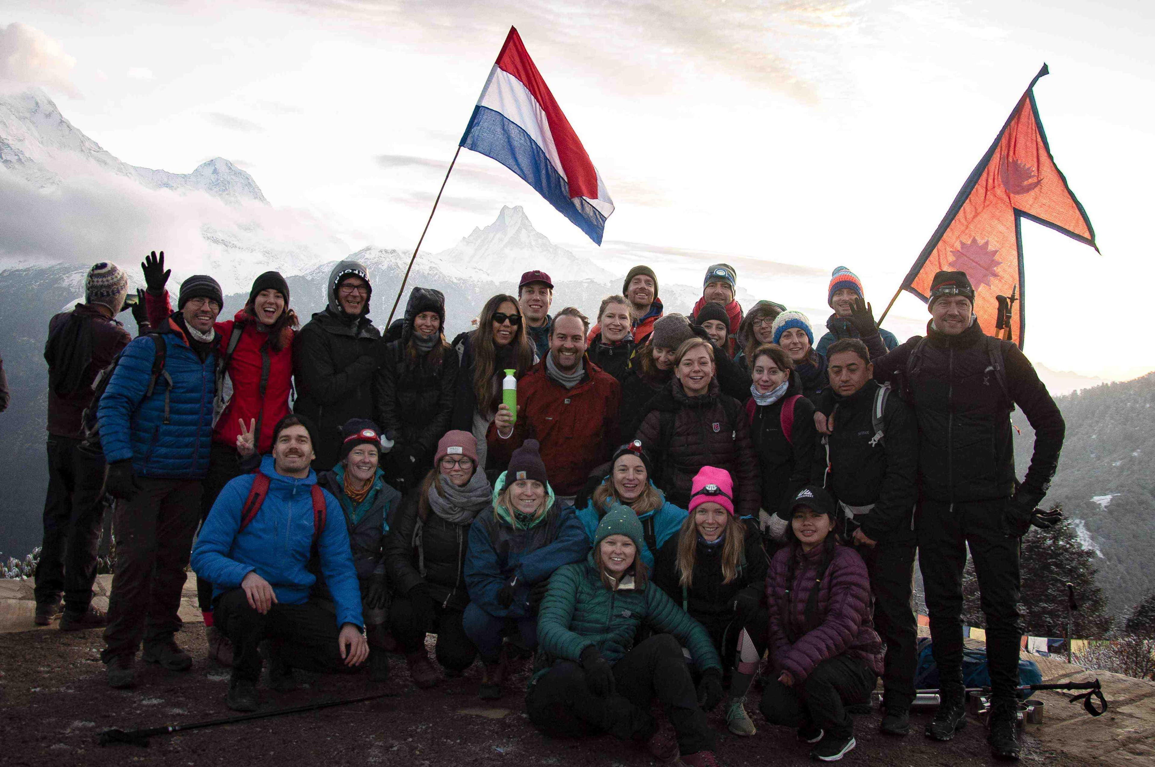 People on a Nepalese hill with a Dutch flag